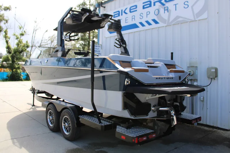 Slide: The Image of A modern 2027 Nautique Super Air Nautique S23 on a trailer in front of a building. - 35