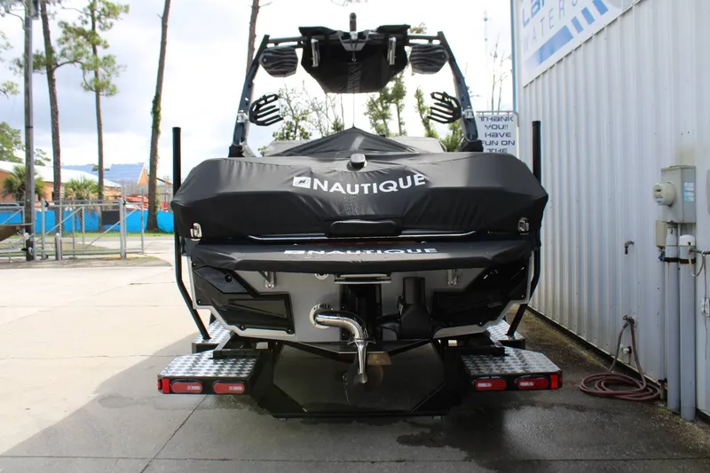 Slide: The Image of The image shows the rear of a 2027 Nautique Super Air Nautique S23 boat on a trailer. - 36