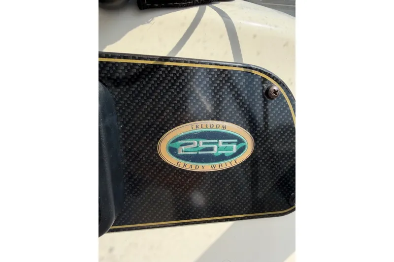 Slide: The Image of 2013 Grady-White Freedom 255 emblem on carbon fiber background. - 17