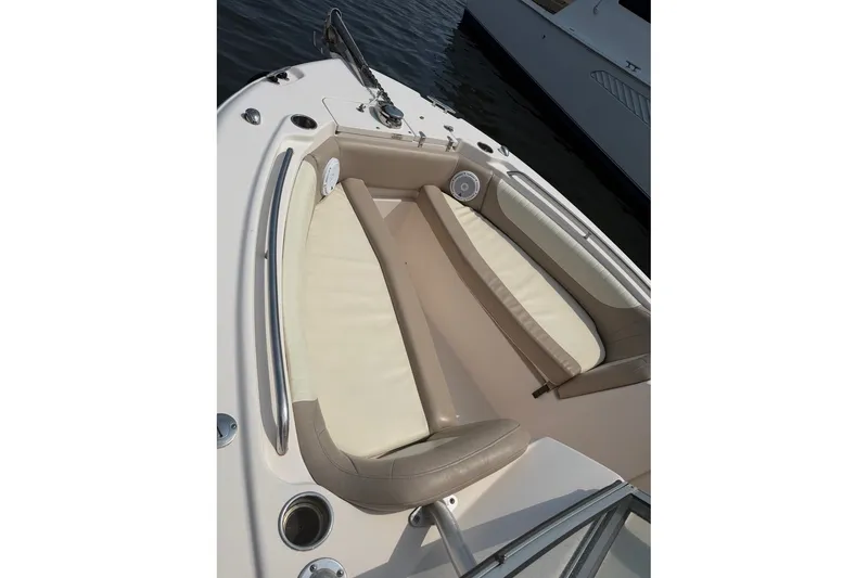 Slide: The Image of 2013 Grady-White Freedom 255 boat interior with cushioned seating and cup holders. - 14