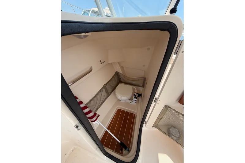 Slide: The Image of Interior view of 2013 Grady-White Freedom 255 boat's compact bathroom area. - 18