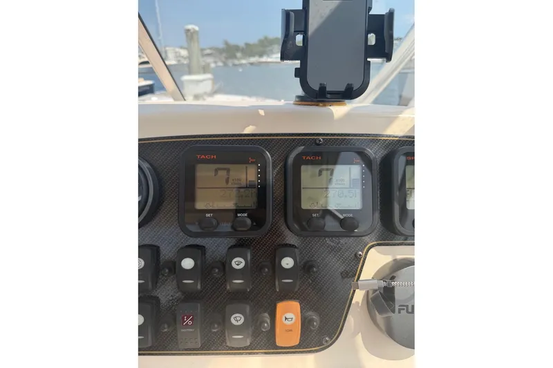 Slide: The Image of Dashboard of 2013 Grady-White Freedom 255 boat with tachometer and controls. - 24