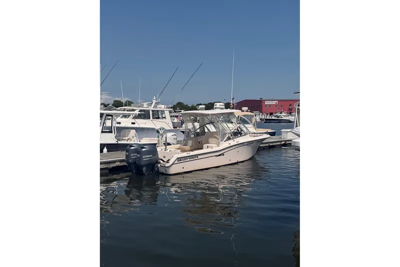 Slide: The Image of 2013 Grady-White Freedom 255 boat docked at marina with Yamaha engines. - 9