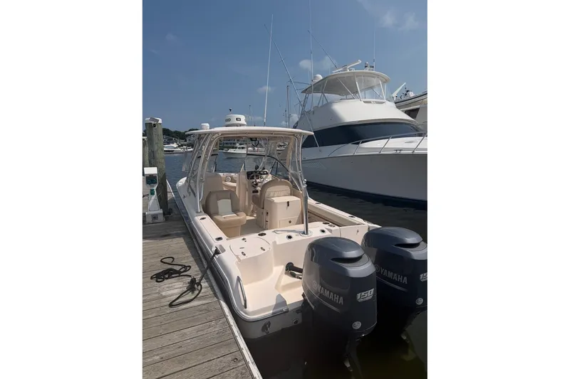 Slide: The Image of 2013 Grady-White Freedom 255 boat docked with twin Yamaha engines. - 11