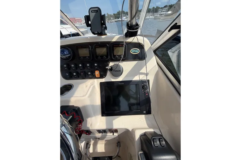 Slide: The Image of 2013 Grady-White Freedom 255 boat dashboard with navigation equipment and controls. - 21