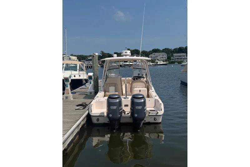 Slide: The Image of 2013 Grady-White Freedom 255 boat docked with dual outboard engines. - 10