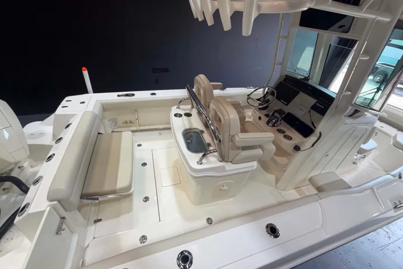 Slide: The Image of 2022 Boston Whaler 250 Outrage boat interior with helm and seating area. - 6