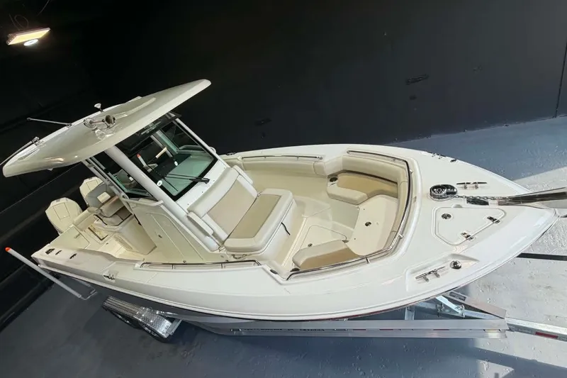 Slide: The Image of 2022 Boston Whaler 250 Outrage boat on trailer, featuring spacious seating and sleek design. - 12