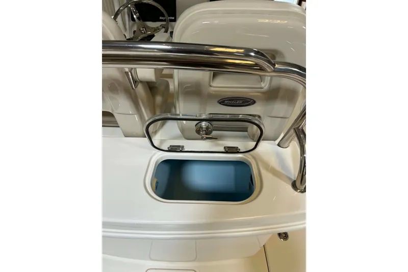 Slide: The Image of 2022 Boston Whaler 250 Outrage boat console with open storage compartment. - 17