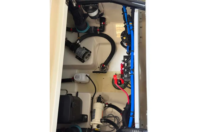 Slide: The Image of 2022 Boston Whaler 250 Outrage engine compartment with wiring and components. - 19