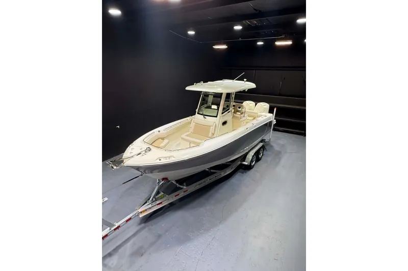 Slide: The Image of 2022 Boston Whaler 250 Outrage boat on trailer in indoor showroom. - 11