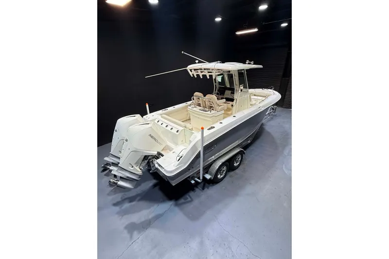Slide: The Image of 2022 Boston Whaler 250 Outrage boat on trailer in indoor setting. - 8