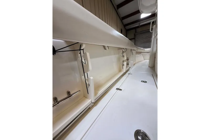 Slide: The Image of 2022 Boston Whaler 250 Outrage interior storage compartment, showcasing sleek design and ample space. - 15