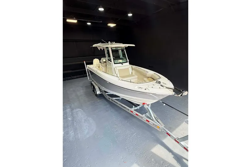 Slide: The Image of 2022 Boston Whaler 250 Outrage boat on trailer in indoor setting. - 9