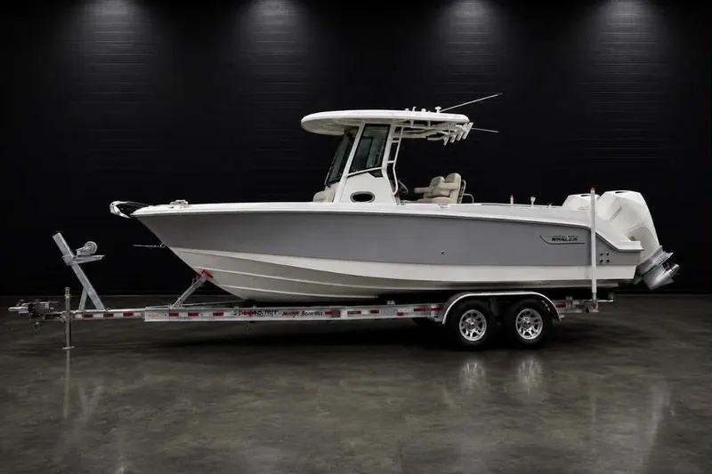 The Image of 2022 Boston Whaler 250 Outrage boat on trailer in showroom setting. - 0