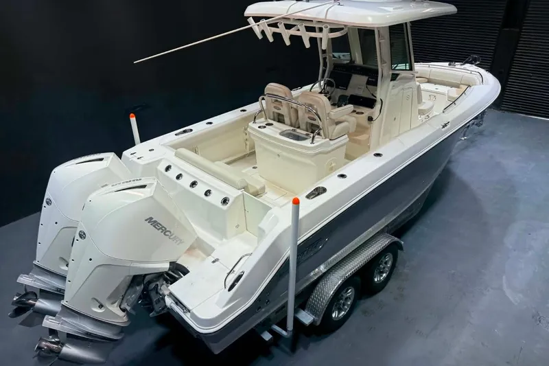 Slide: The Image of 2022 Boston Whaler 250 Outrage boat with dual Mercury engines on a trailer. - 4