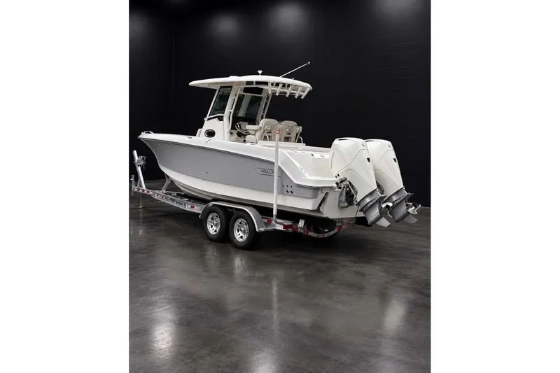 Slide: The Image of 2022 Boston Whaler 250 Outrage boat on trailer in showroom. - 1