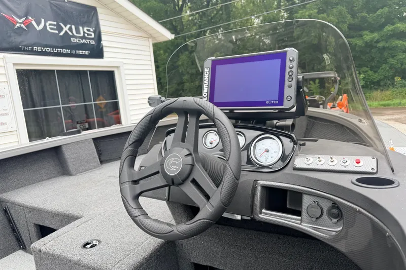 Slide: The Image of 2027 Crestliner 1850 Kodiak SC boat dashboard with steering wheel and Lowrance Elite display. - 5
