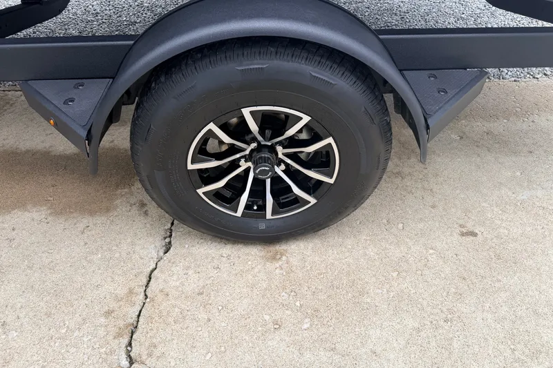 Slide: The Image of Trailer wheel of 2027 Crestliner 1850 Kodiak SC on concrete surface. - 11