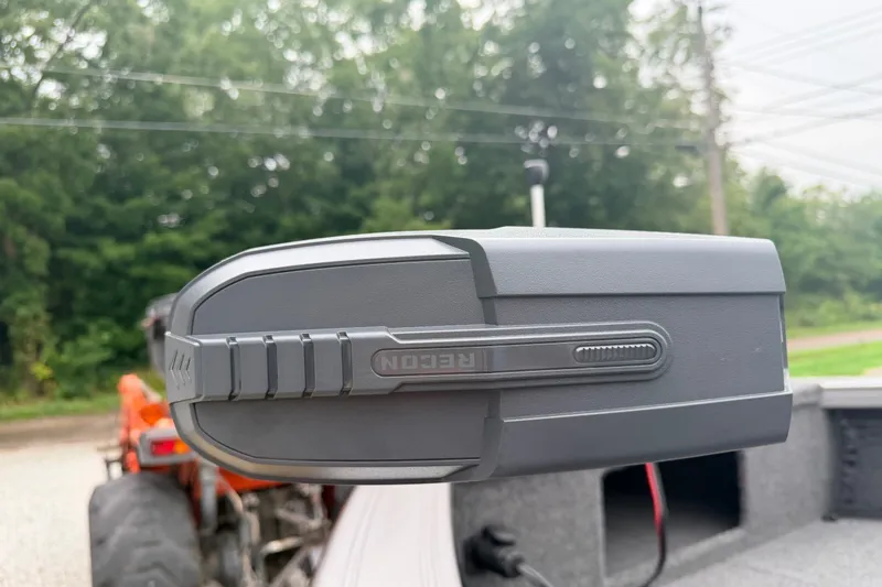 Slide: The Image of Close-up of a 2027 Crestliner 1850 Kodiak SC boat component with greenery in the background. - 8