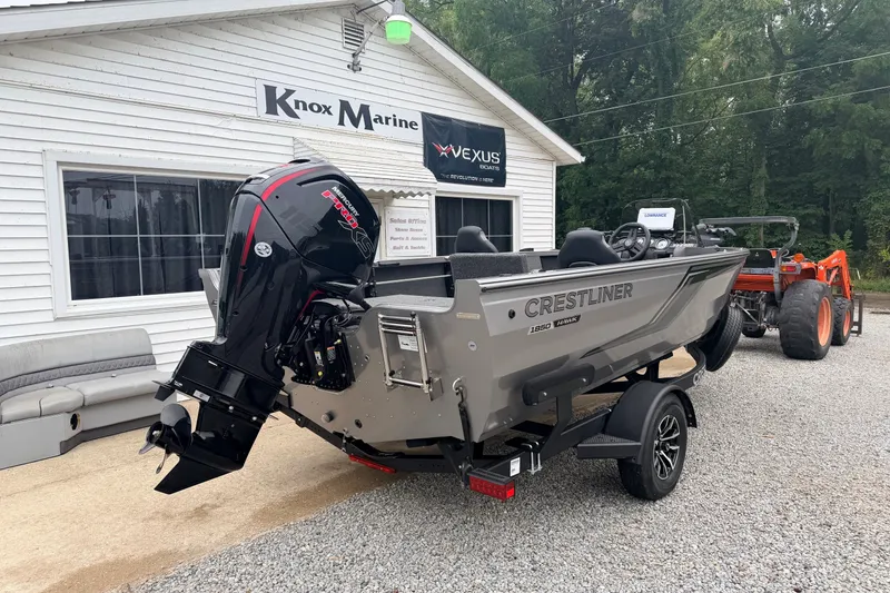 Slide: The Image of 2027 Crestliner 1850 Kodiak SC boat at Knox Marine dealership, featuring powerful outboard motor. - 2
