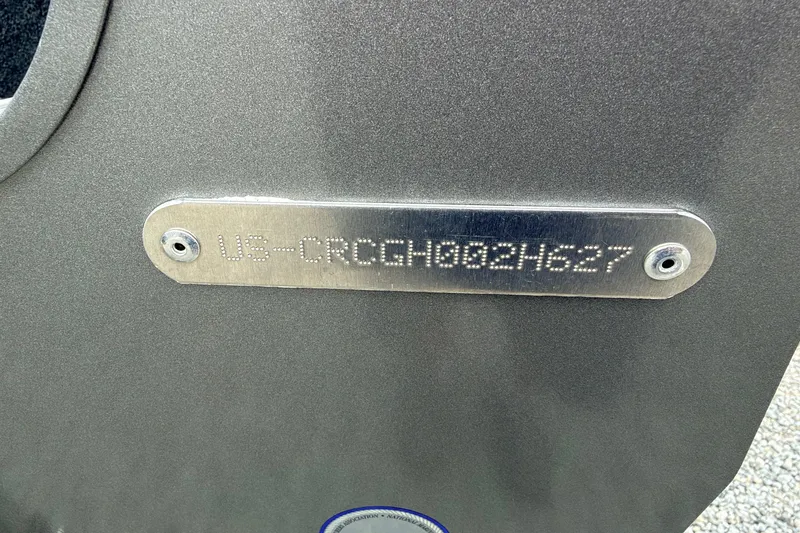 Slide: The Image of Close-up of a metal plaque with an engraved serial number on a boat. - 4