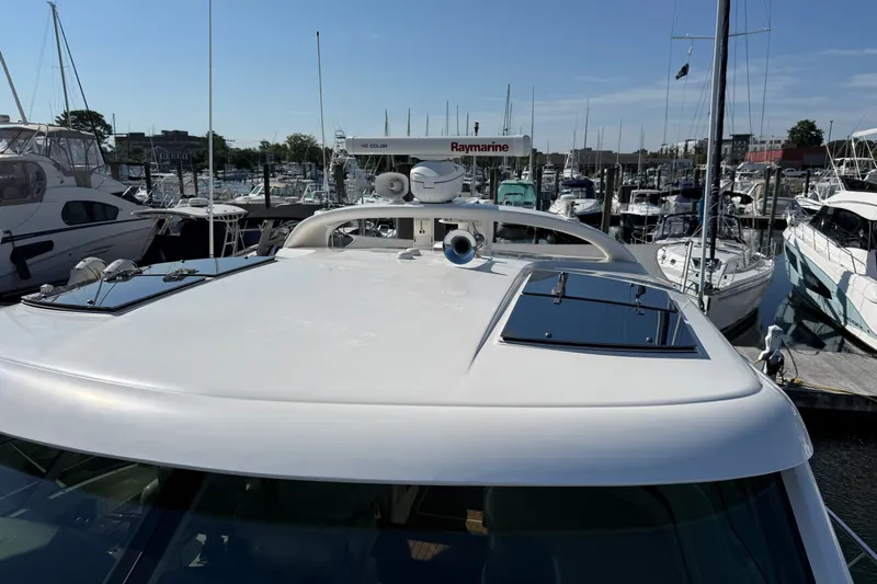Slide: The Image of 2005 Sea Ray 48 Sundancer yacht docked at marina, featuring sleek design and advanced navigation equipment. - 29