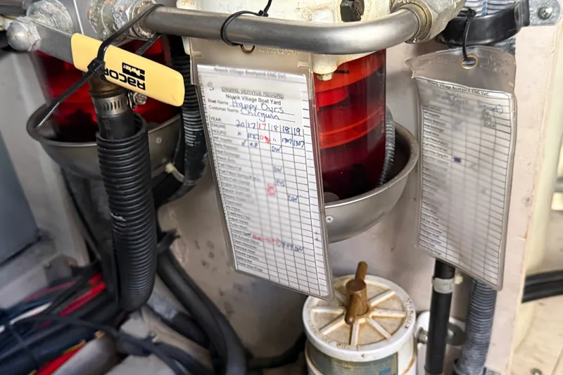 Slide: The Image of Engine maintenance records on a 2005 Sea Ray 48 Sundancer boat, featuring Racor fuel filter. - 115