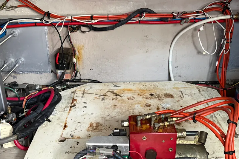 Slide: The Image of Engine room of a 2005 Sea Ray 48 Sundancer with visible wiring and components. - 116