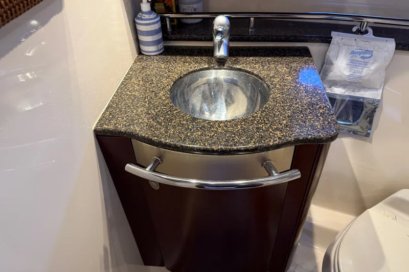 Slide: The Image of Luxurious bathroom sink on 2005 Sea Ray 48 Sundancer yacht with granite countertop. - 57