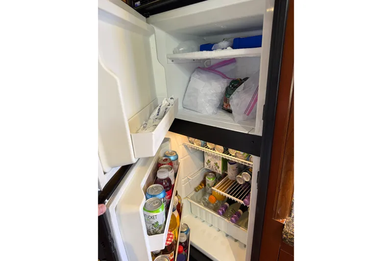 Slide: The Image of Refrigerator stocked with drinks and ice on a 2005 Sea Ray 48 Sundancer yacht. - 75