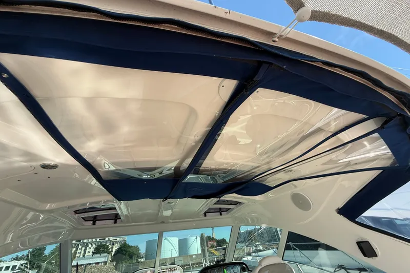 Slide: The Image of Interior view of 2005 Sea Ray 48 Sundancer yacht with blue canopy and clear panels. - 15