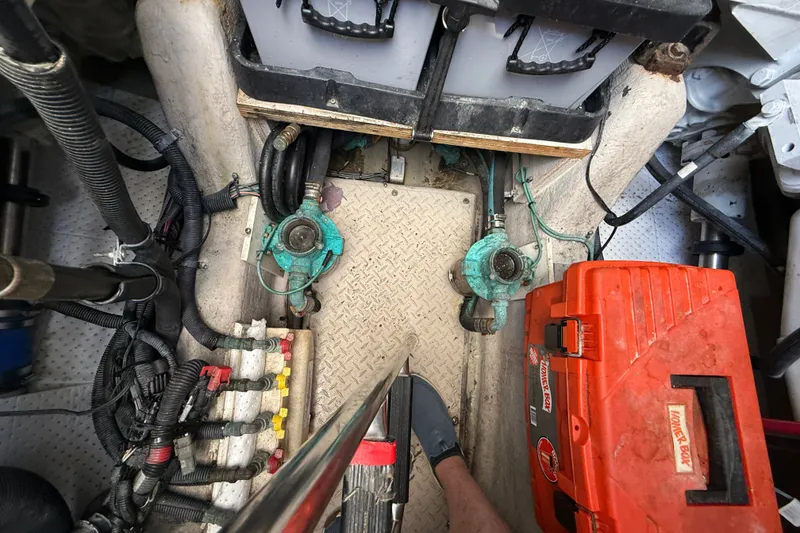 Slide: The Image of Engine room of 2005 Sea Ray 48 Sundancer with tools and equipment visible. - 108
