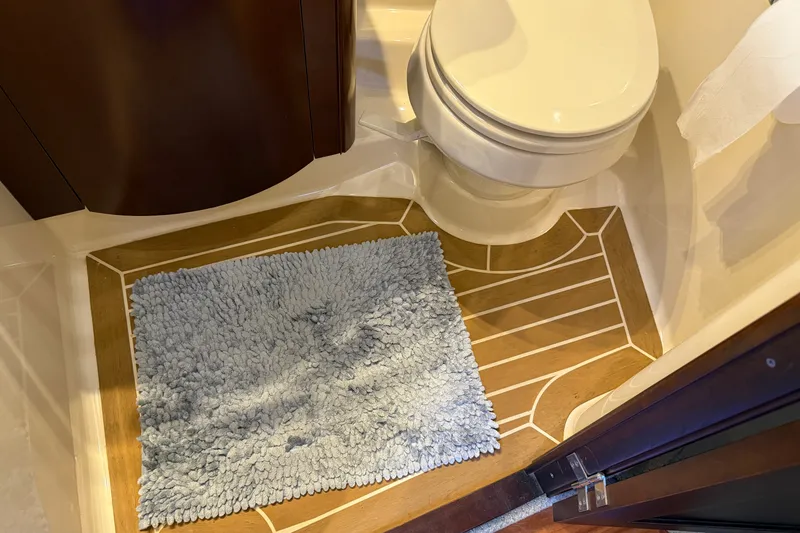 Slide: The Image of Bathroom interior of 2005 Sea Ray 48 Sundancer yacht with toilet and blue rug. - 65