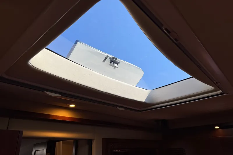 Slide: The Image of Skylight view from inside a 2005 Sea Ray 48 Sundancer yacht, showcasing blue sky. - 83