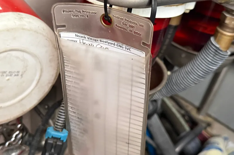 Slide: The Image of Maintenance tag on a 2005 Sea Ray 48 Sundancer engine compartment. - 114