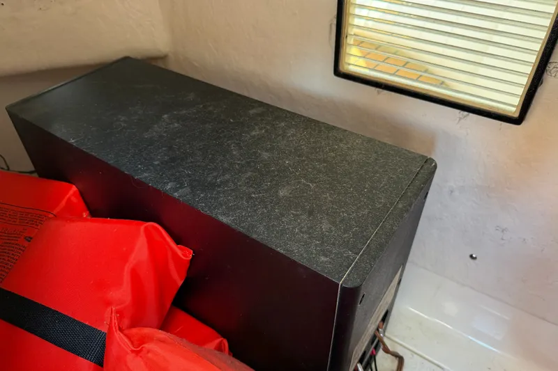 Slide: The Image of Storage compartment with red life jackets on a 2005 Sea Ray 48 Sundancer boat. - 47