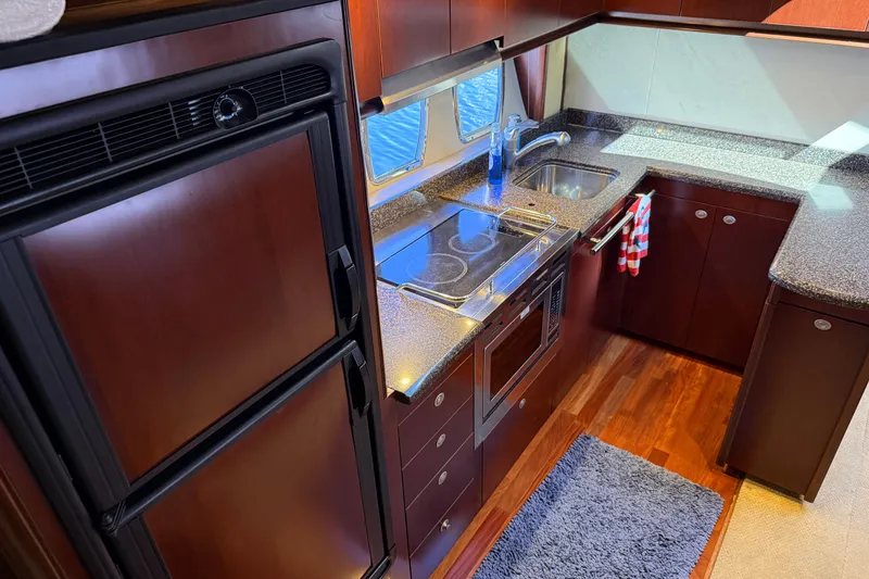 Slide: The Image of Luxurious kitchen interior of 2005 Sea Ray 48 Sundancer yacht with modern appliances. - 68