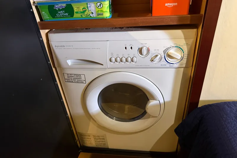 Slide: The Image of Compact washing machine in a 2005 Sea Ray 48 Sundancer yacht interior. - 99