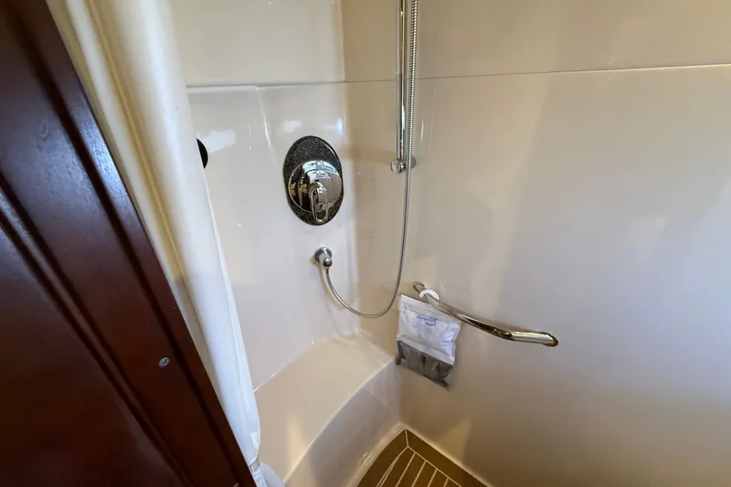 Slide: The Image of Shower area in 2005 Sea Ray 48 Sundancer yacht, featuring chrome fixtures and a handrail. - 93