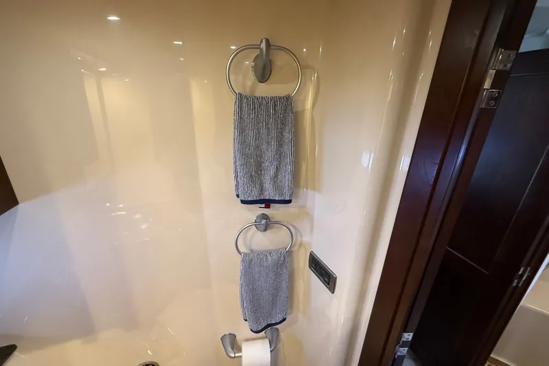 Slide: The Image of Bathroom interior of 2005 Sea Ray 48 Sundancer with towels and fixtures. - 59