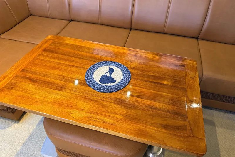 Slide: The Image of Luxurious wooden table on 2005 Sea Ray 48 Sundancer yacht, with leather seating. - 80