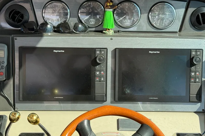 Slide: The Image of Dashboard of 2005 Sea Ray 48 Sundancer with Raymarine displays and gauges. - 40