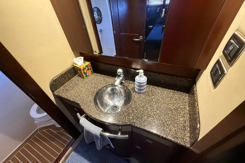 Slide: The Image of Luxurious bathroom vanity in 2005 Sea Ray 48 Sundancer yacht, featuring granite countertop. - 91