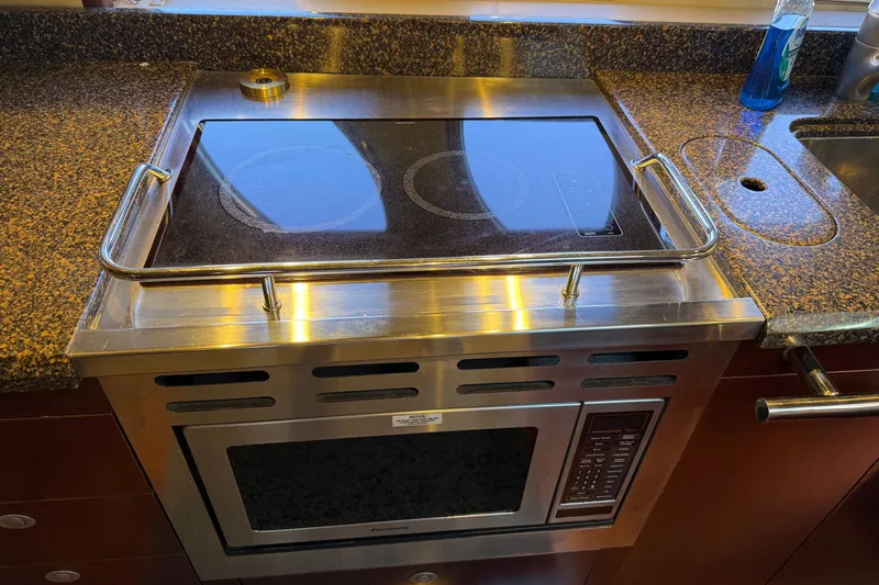 Slide: The Image of Stainless steel stove and microwave in 2005 Sea Ray 48 Sundancer yacht kitchen. - 71