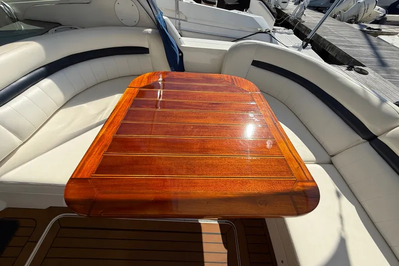 Slide: The Image of Luxurious 2005 Sea Ray 48 Sundancer yacht interior with polished wooden table. - 10