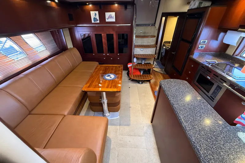 Slide: The Image of Luxurious interior of 2005 Sea Ray 48 Sundancer yacht with leather seating and modern kitchen. - 66