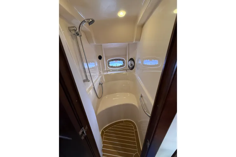 Slide: The Image of Shower area in 2005 Sea Ray 48 Sundancer yacht with sleek design and porthole windows. - 61