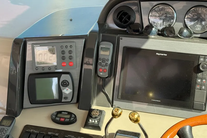 Slide: The Image of Control panel of a 2005 Sea Ray 48 Sundancer with navigation instruments and gauges. - 41