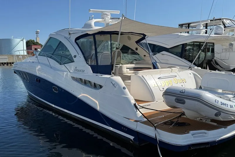 Slide: The Image of 2005 Sea Ray 48 Sundancer yacht docked, featuring sleek design and luxury amenities. - 118
